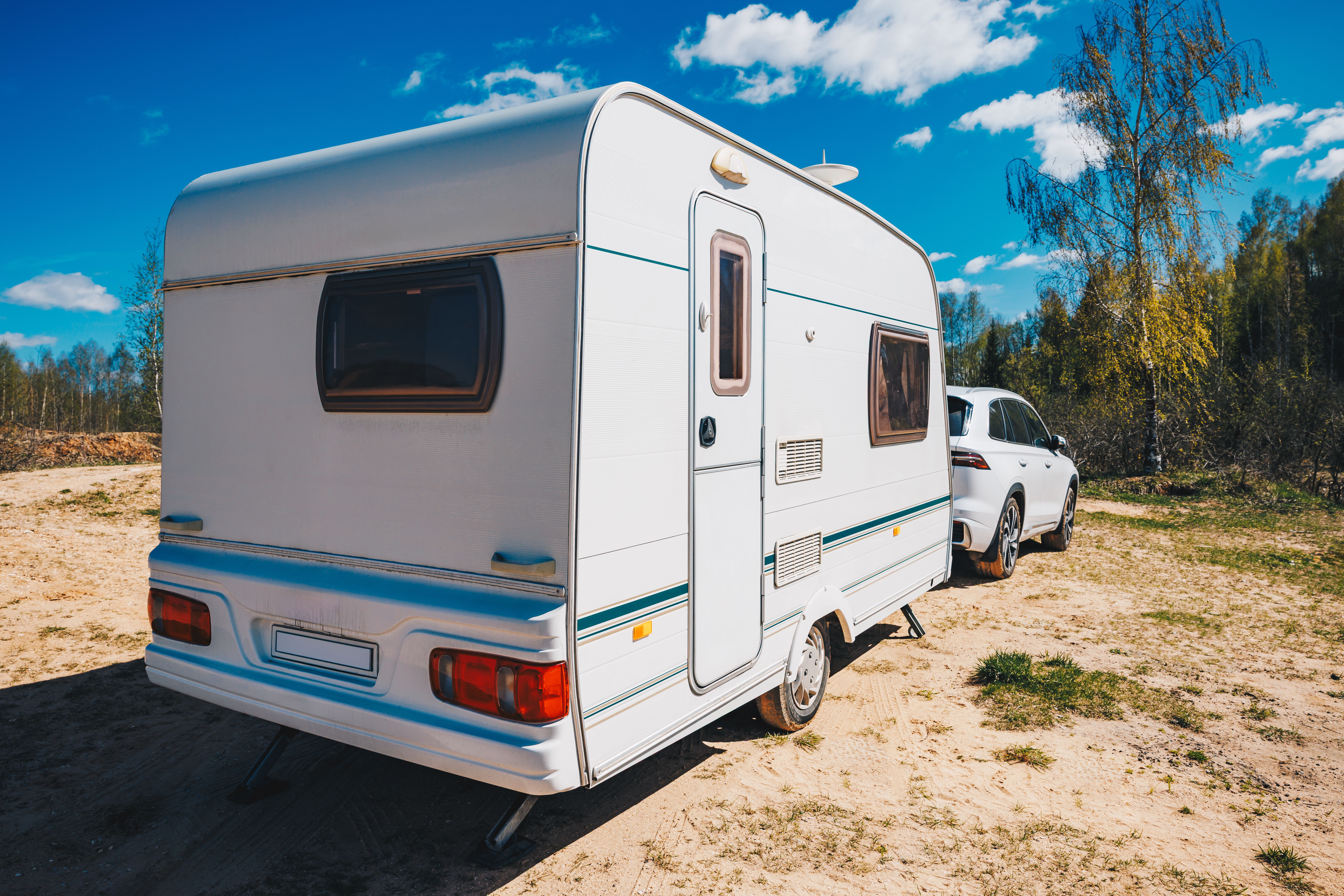 white-trailer-caravan-car-is-parked-on-the-side-of-road
